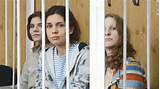 Members of female punk band 'Pussy Riot' sit behind the bars during a ...