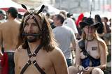 Man pulling buggy, woman with whip at Folsom Street Fair